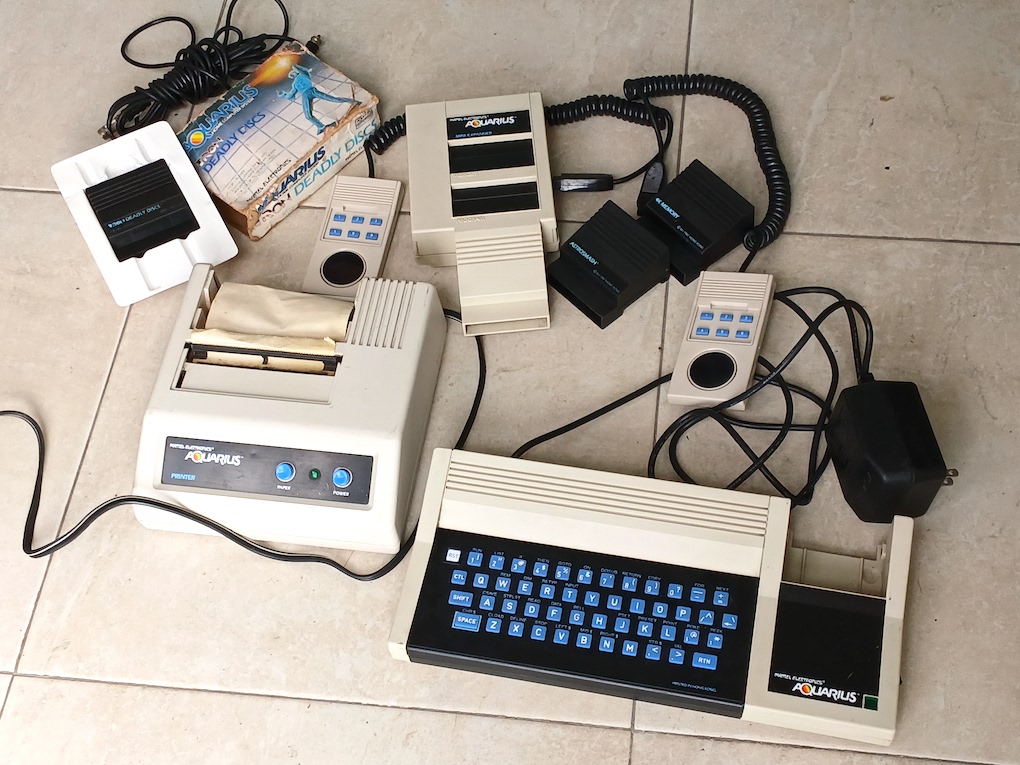 Mattel Aquarius computer with expansion board, two games, cables, and the Aquarius printer.